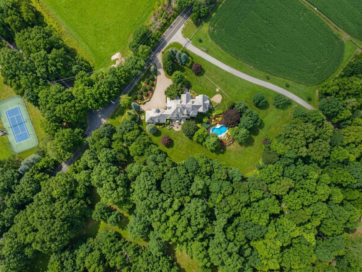 Top-down aerial view of the estate, grounds, and tennis court
